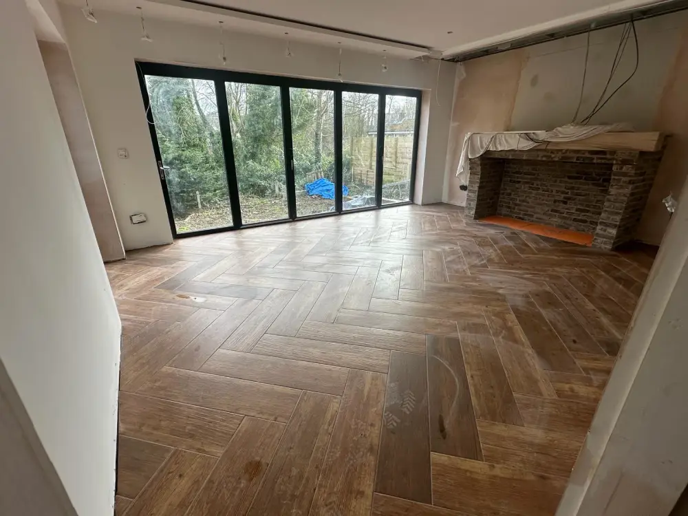 Large room with wood flooring and oak mantlepiece